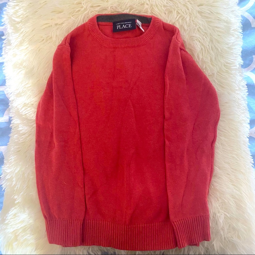 Children place sweater